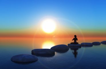 3D female in yoga pose on stepping stones in the ocean